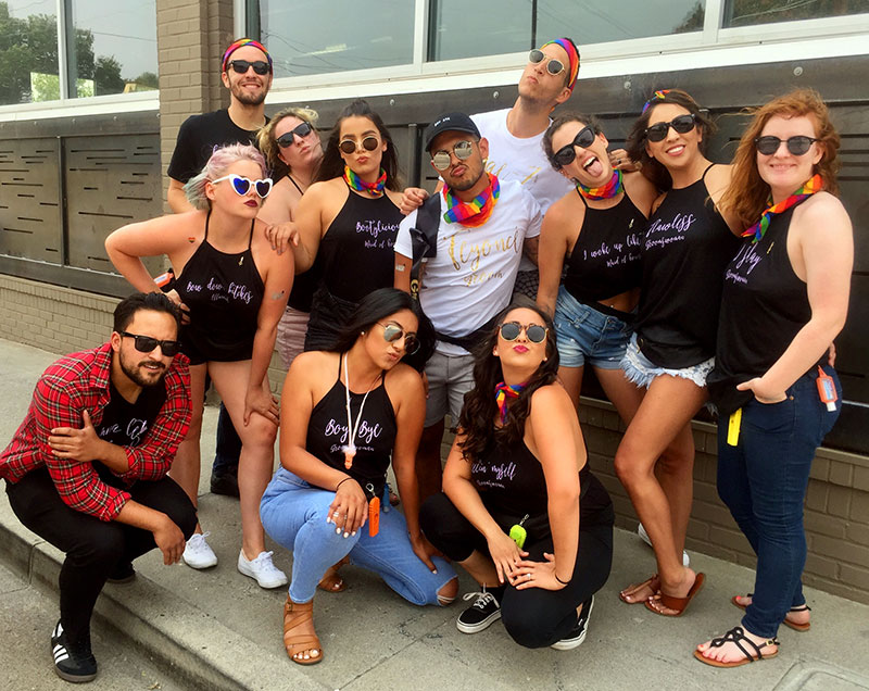 Group of young women and men in black or white shirts posing evocatively