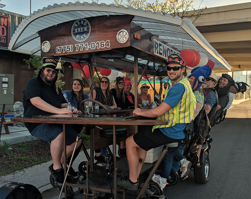 Group of men and women in costume on the Brew Bike