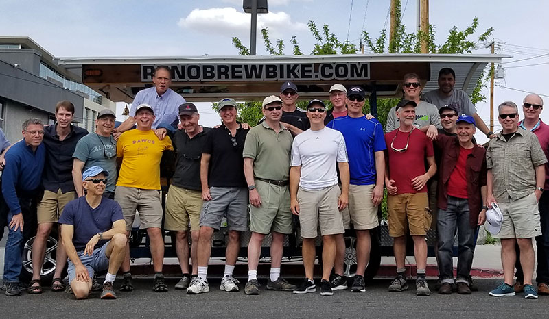 Corporate staff as group in front of Brew Bike