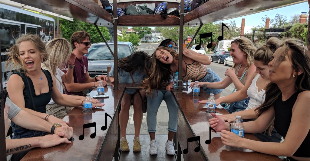 Brew Bike passengers on the pedal trolley maximizing their tour value by singing and laughing along with their custom playlist.