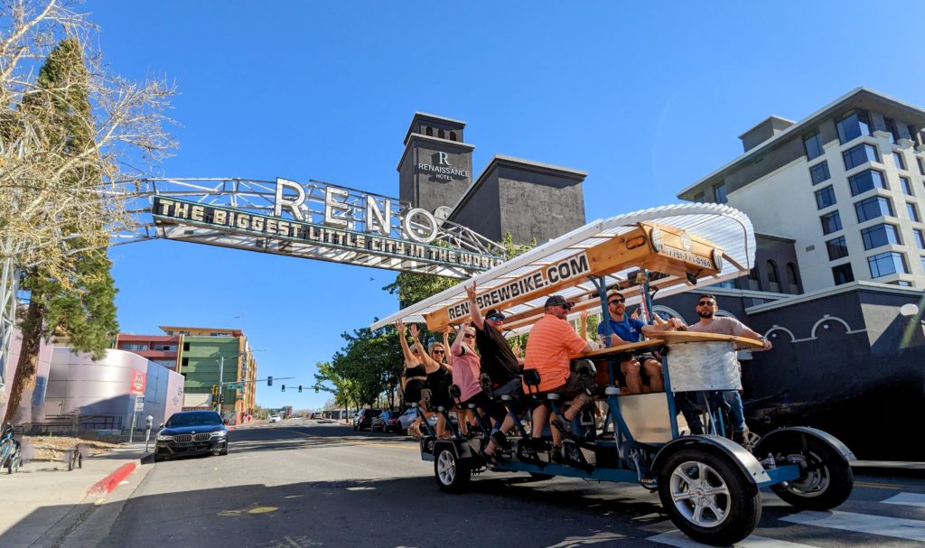 Reno Brew Bike Private Bike reservation celebrating as they go through the Old Reno Arch on Lake Street
