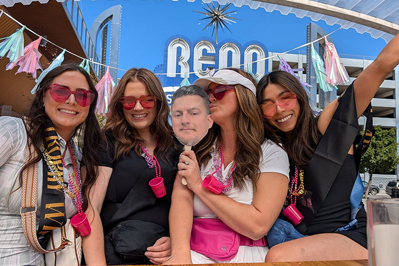 Bachelorette party tour in front of Reno sign
